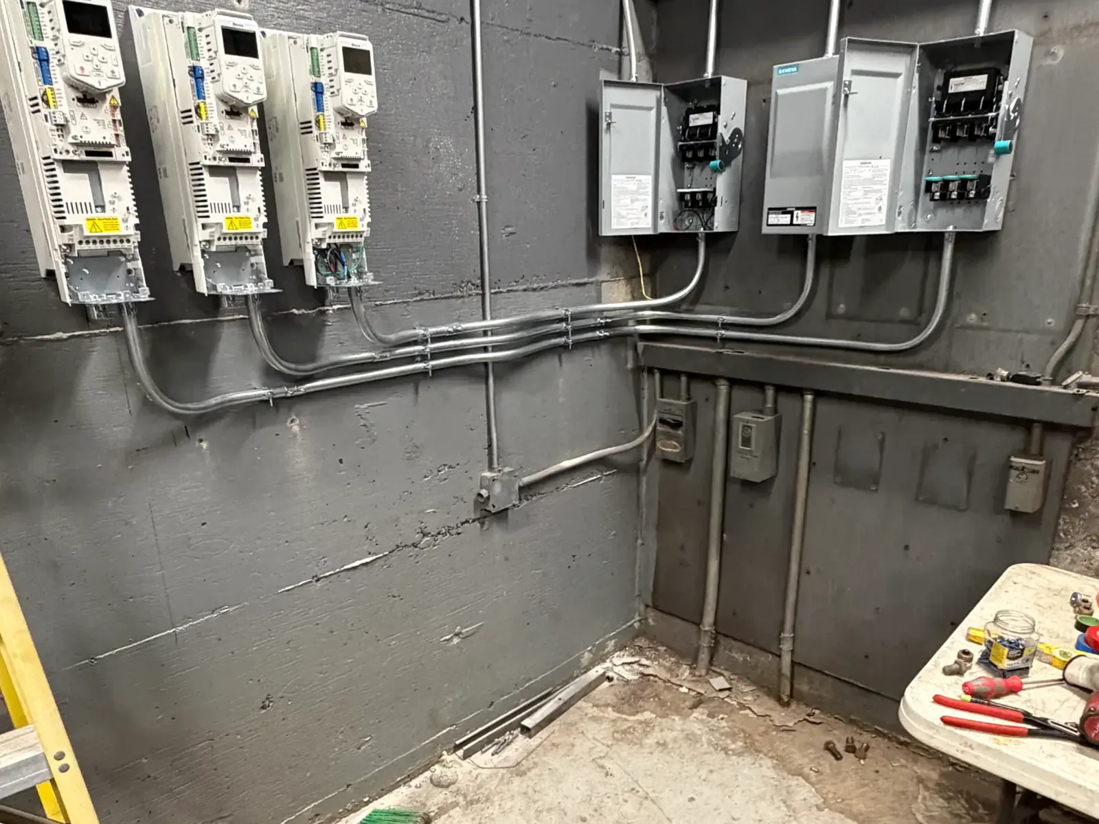 Three variable frequency drives mounted and piped to disconnect switches
